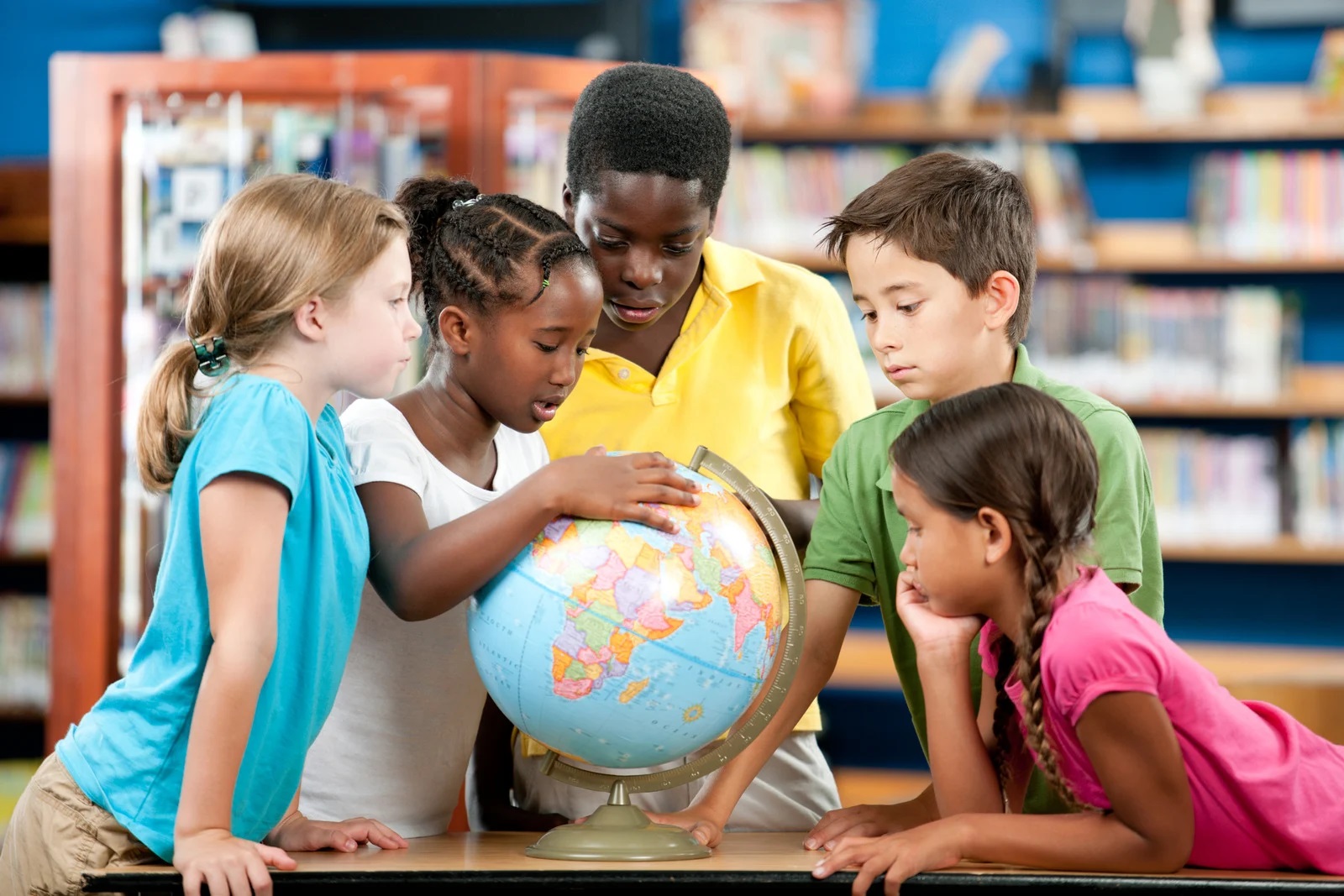 Children learning about a place with a globe